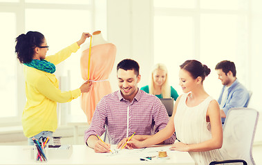 Image showing smiling fashion designers working in office