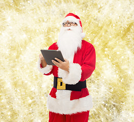 Image showing man in costume of santa claus with tablet pc