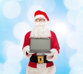 Image showing man in costume of santa claus with laptop