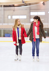 Image showing happy girls friends on skating rink