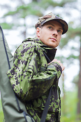 Image showing young soldier or hunter with gun in forest