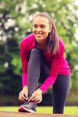 Image showing smiling woman exercising outdoors