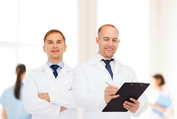 Image showing smiling doctors in white coats with clipboard