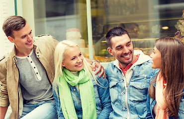 Image showing group of smiling friends walking in the city