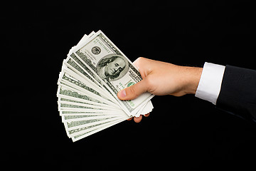 Image showing close up of male hands holding dollar cash money