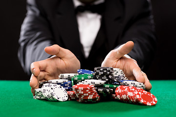 Image showing poker player with chips at casino table