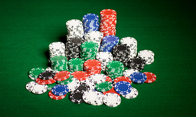 Image showing close up of casino chips on green table surface