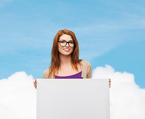 Image showing smiling teenage girl in glasses with white board