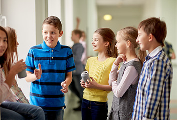 Image showing group of school kids with soda cans in corridor