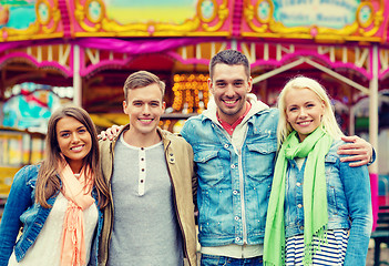 Image showing group of smiling friends in amusement park