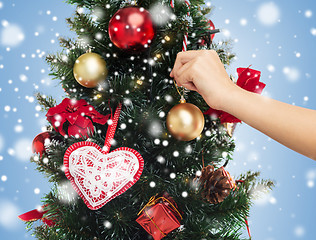 Image showing close up of hand with christmas tree decoration