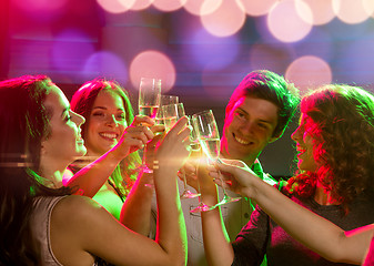 Image showing smiling friends with glasses of champagne in club