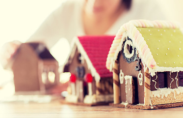 Image showing close up of woman making gingerbread houses