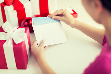 Image showing close up of woman with letter and presents