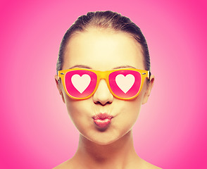 Image showing girl in pink sunglasses blowing kiss