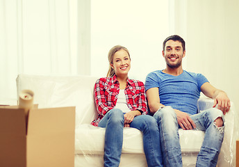 Image showing smiling couple relaxing on sofa in new home