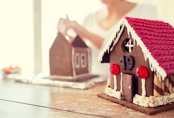 Image showing close up of woman making gingerbread houses