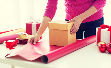 Image showing close up of woman decorating christmas presents