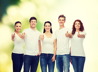 Image showing smiling teenagers in t-shirts showing thumbs up