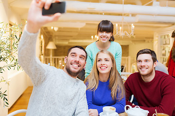 Image showing group of friends taking selfie with smartphone