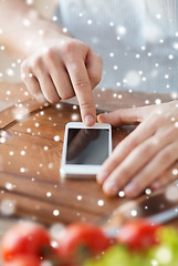 Image showing closeup of man reading recipe from smartphone