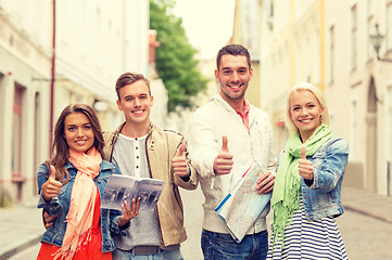 Image showing group of smiling friends with city guide and map