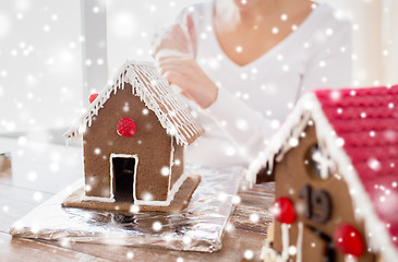 Image showing close up of woman making gingerbread houses