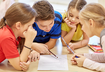 Image showing group of students talking and writing at school