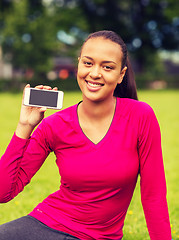 Image showing smiling african american woman with smartphone