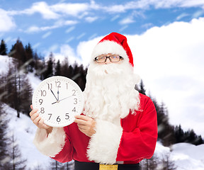 Image showing man in costume of santa claus with clock