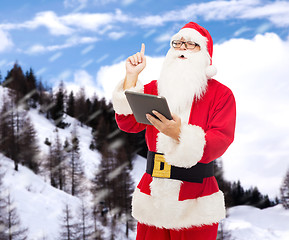 Image showing man in costume of santa claus with tablet pc