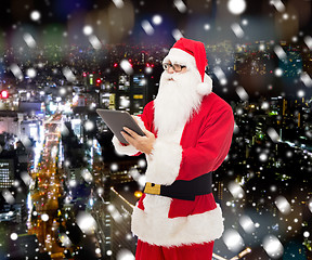 Image showing man in costume of santa claus with tablet pc