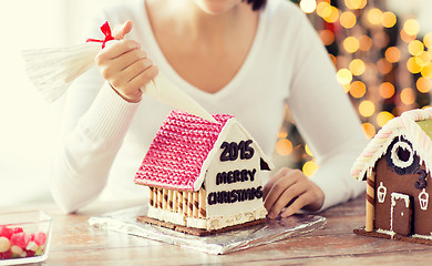 Image showing close up of woman making gingerbread houses