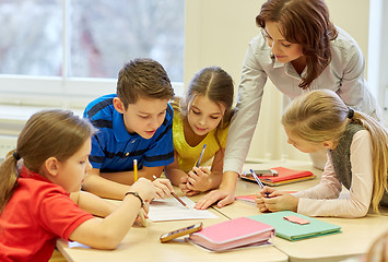 Image showing group of school kids writing test in classroom