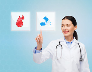 Image showing smiling doctor or nurse pointing to pills icon