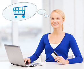 Image showing smiling woman with laptop computer and credit card