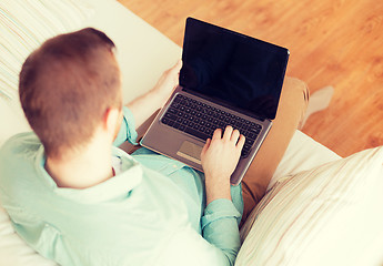 Image showing close up of man working with laptop at home