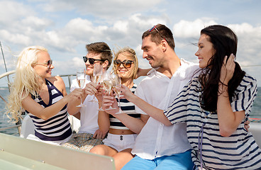 Image showing smiling friends with glasses of champagne on yacht