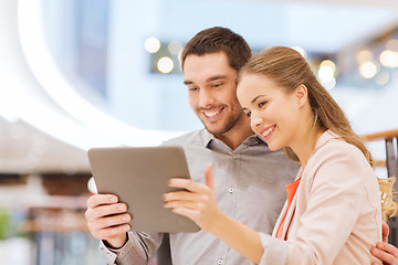 Image showing happy couple with tablet pc taking selfie in mall