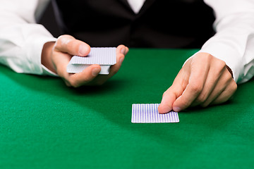 Image showing holdem dealer with playing cards