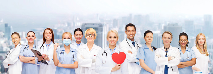 Image showing smiling doctors and nurses with red heart