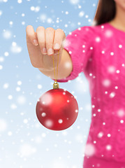 Image showing close up of woman in sweater with christmas ball