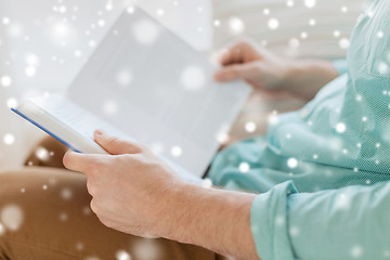 Image showing close up of man reading book at home