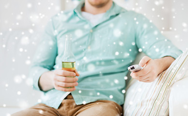 Image showing man with beer and remote control at home