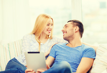 Image showing smiling happy couple with tablet pc at home