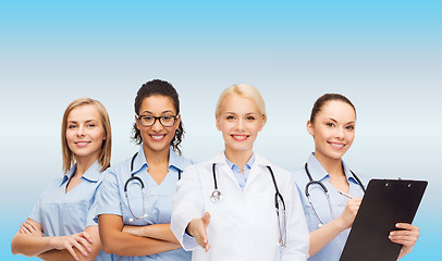 Image showing smiling female doctor and nurses with stethoscope