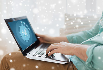 Image showing close up of man working with laptop at home