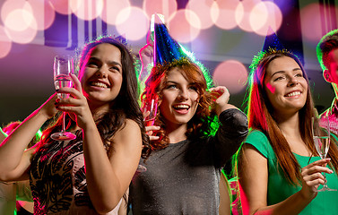 Image showing smiling friends with glasses of champagne in club