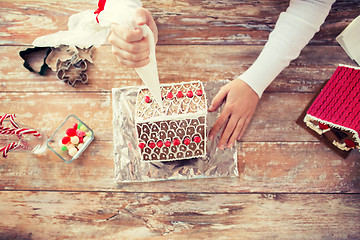 Image showing close up of woman making gingerbread houses