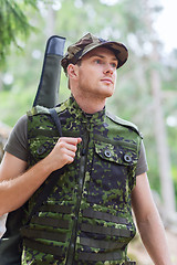 Image showing young soldier or hunter with gun in forest